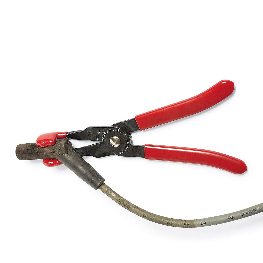 Spark Plug Pliers holding on to a spark plug | Construction Pro Tips