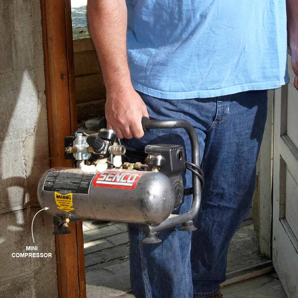 A man holding a miniature compressor | Construction Pro Tips