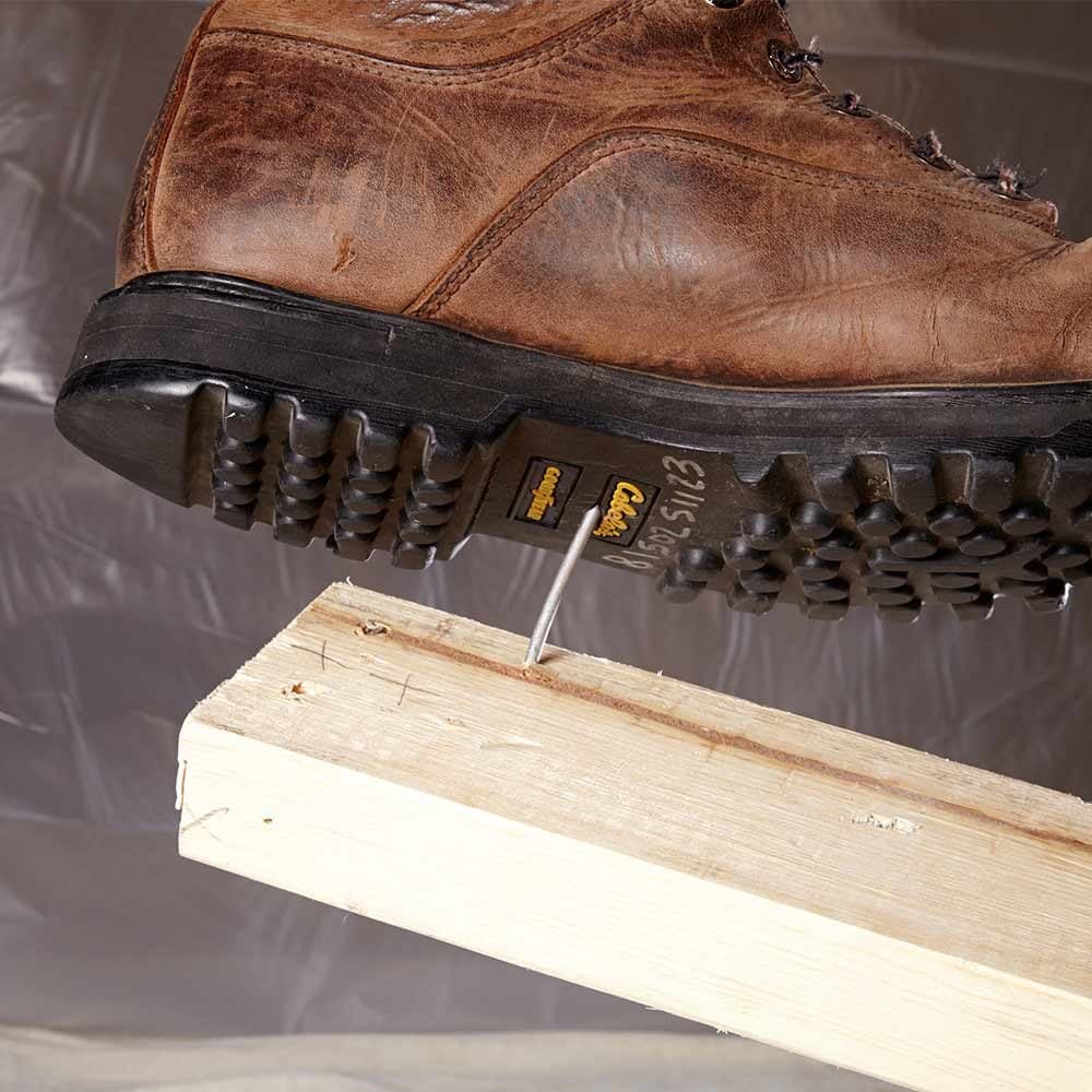 A boot about to step into a nail | Construction Pro Tips