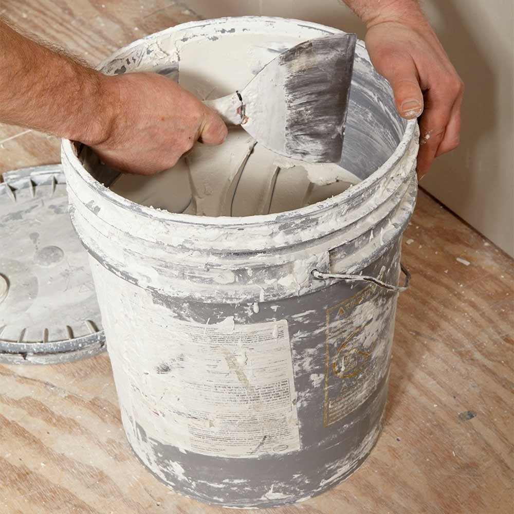 scraping the inside of the mud bucket | Construction Pro Tips