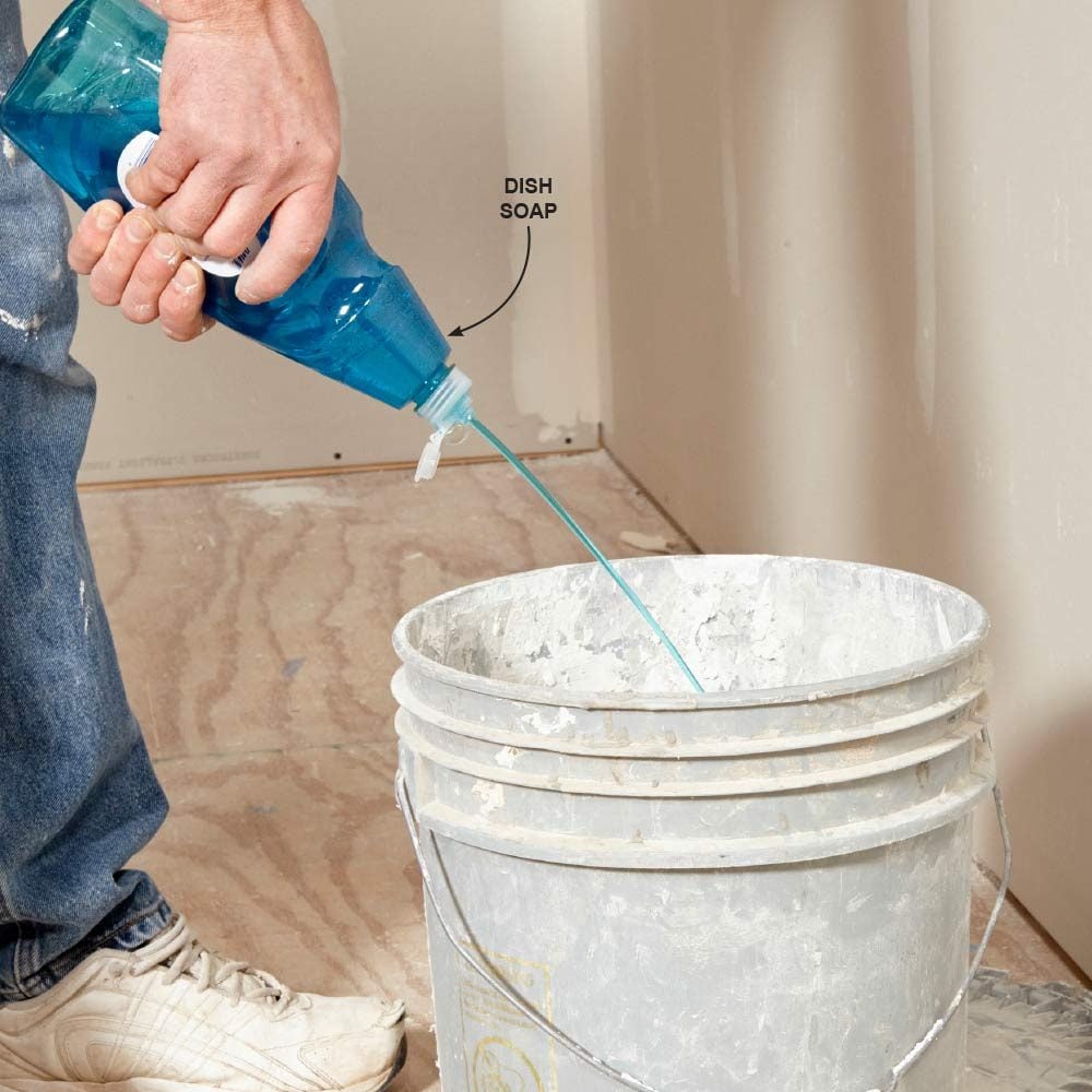 Squirting dish soap into a mud bucket | Construction Pro Tips