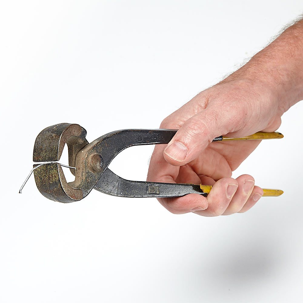 Holding brad nails in pliers | Construction Pro Tips