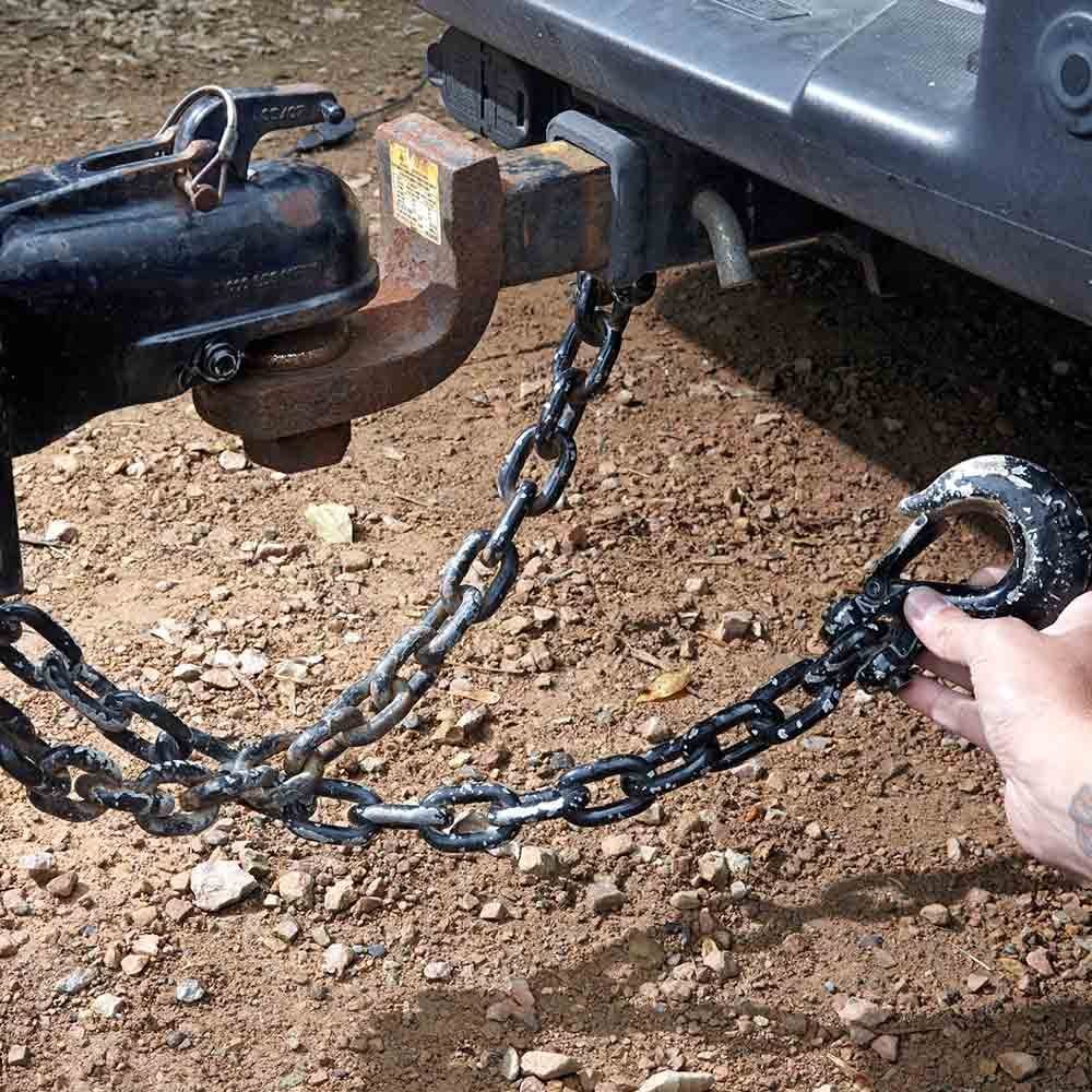 Holding a hook next to a trailer hitch | Construction Pro Tips