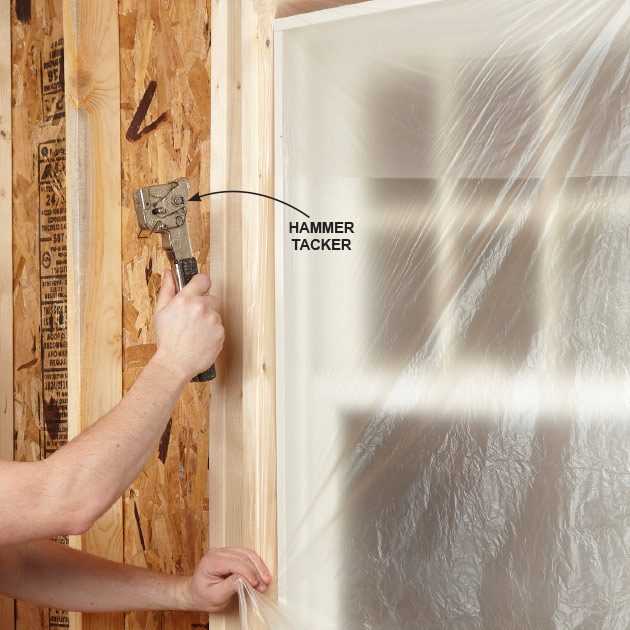Using a stapler to cover a window with plastic | Construction Pro Tips