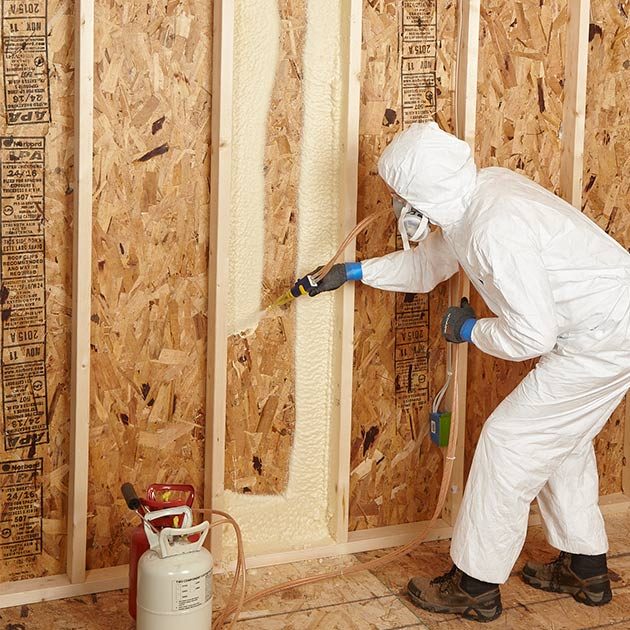 Man spraying foam insulation in a picture frame pattern | Construction Pro Tips