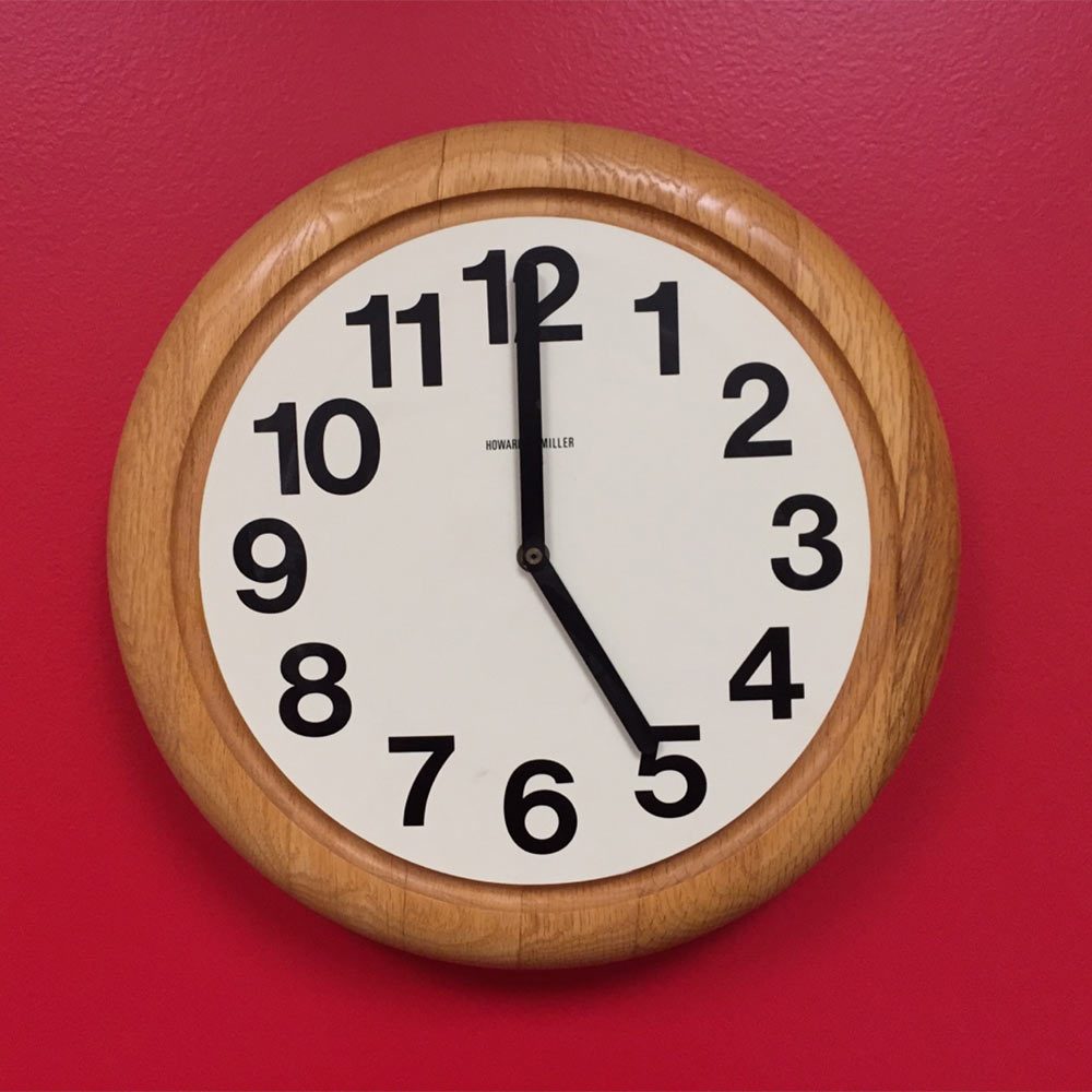 A clock on a red wall | Construction Pro Tips