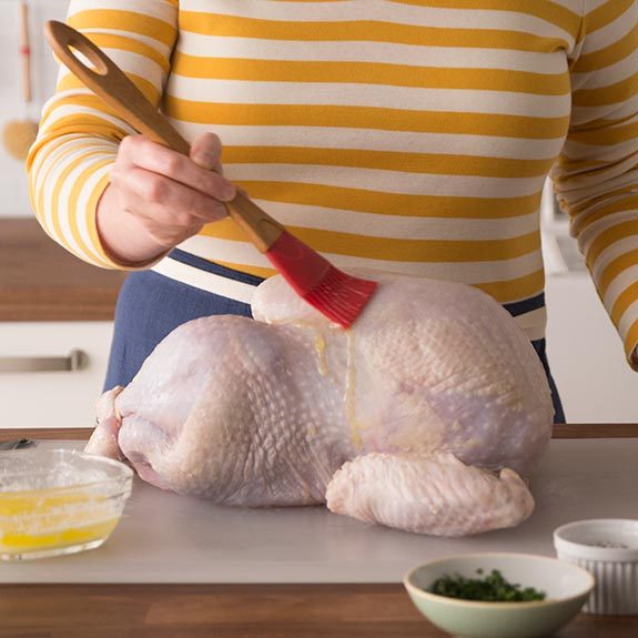 Preparing a turkey for roasting in an oven bag.