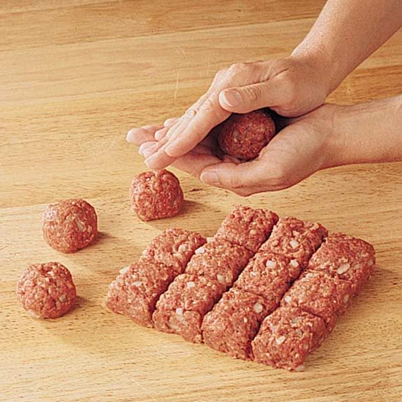 Gently rolling squares into round meatballs.